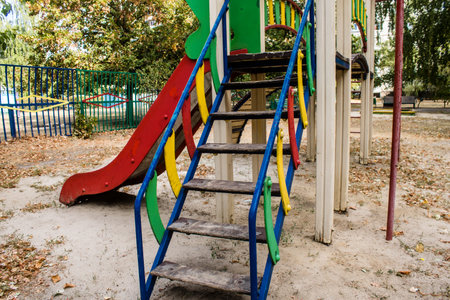 Kharkiv, Ukraine, September 12, 2024 Abandoned playground in front of a damaged building in the Saltivka district. Children were evacuated from this place after a massive attacks of Russian missiles.の写真素材