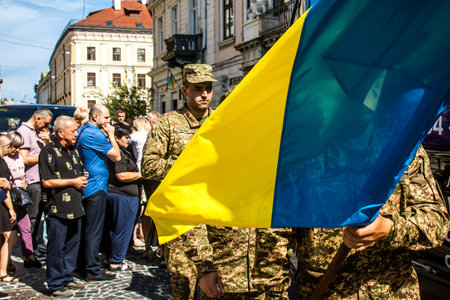 Lviv, Ukraine, August 23, 2024 Military funeral ceremony in front of the Church of the Most Holy Apostles Peter and Paul for three Ukrainian soldiers who died in a battle against the Russian army.のeditorial素材