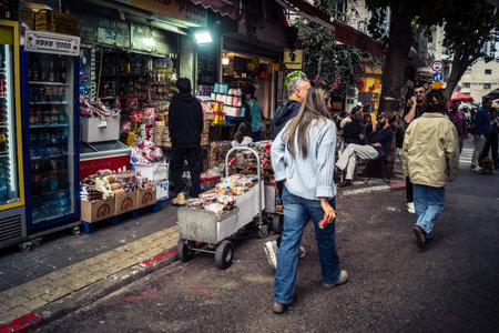 Tel Aviv, Israel, March 13, 2026 People shopping at Levinsky Market, daily life scene with customers and vendors in traditional Mediterranean market.のeditorial素材