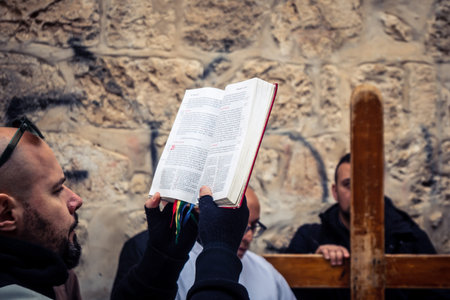 Jerusalem, Israel, 19 February 2026  Italian Christian pilgrims led by a priest conduct an official procession along the Via Dolorosa in the Old City. Devotees carry a cross through narrow streets.のeditorial素材