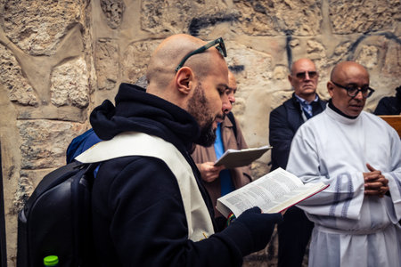 â€‹Jerusalem, Israel - February 21, 2026: Christian pilgrims carry large wooden crosses and...