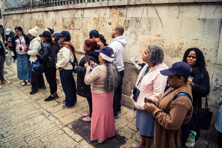 â€‹Jerusalem, Israel - February 21, 2026: Christian pilgrims carry large wooden crosses and...