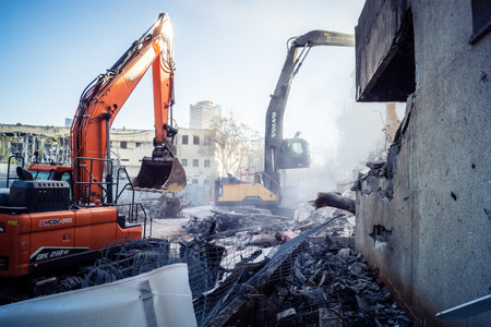 Tel Aviv, Israel, March 1, 2026 Construction cranes and heavy equipment working to demolish a...