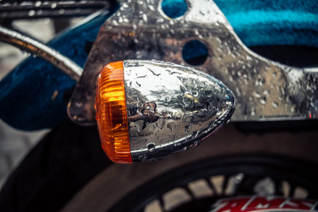 Tel Aviv, Israel, March 21, 2026 Close up of a Harley Davidson Seventy Two chopper motorcycle parked on a wet street under the rain with reflections and urban atmosphere.のeditorial素材