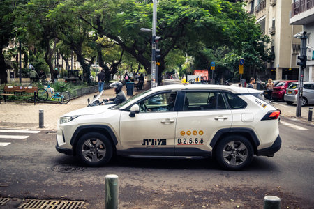 Tel Aviv, Israel, January 14, 2026 Taxis navigate along the Rothschild BoulevardÂ a vibrant,...