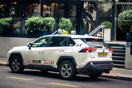 Tel Aviv, Israel, January 14, 2026 Taxis navigate along the Rothschild BoulevardÂ a vibrant,...
