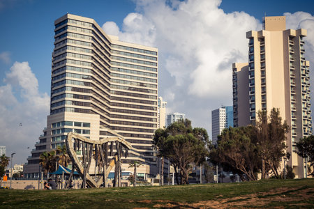 Tel Aviv, Israel, âMarch 16, 2026 Coastal view featuring the modern architectural skyline of luxury hotels and high-rise buildings along the Herbert Samuel beachfront. The image captures the contrast between the rhythmic waves of the Mediterranean Sea aのeditorial素材