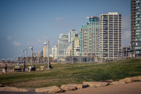 Tel Aviv, Israel, âMarch 16, 2026 Coastal view featuring the modern architectural skyline of luxury hotels and high-rise buildings along the Herbert Samuel beachfront. The image captures the contrast between the rhythmic waves of the Mediterranean Sea aのeditorial素材