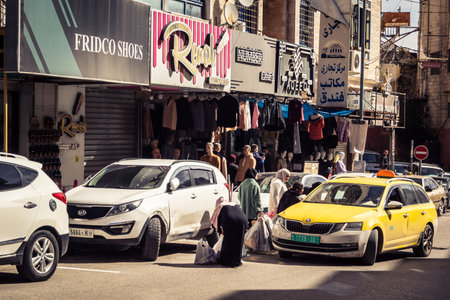 Hebron, West Bank, February 7, 2026 Vibrant street life and busy markets in the heart of Hebron in Palestine. Yellow taxis and bustling crowds navigate the busy thoroughfares.のeditorial素材