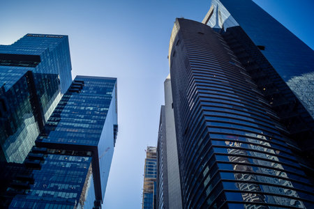 Tel Aviv, Israel, March 17, 2026 Architectural study of the geometric glass surfaces of the modern towers following a period of regional security alerts. The image captures the sunlight reflecting off the structural steel and the organic integration of thのeditorial素材