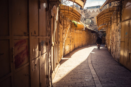 Hebron, West Bank, January 29, 2026 Sealed shop doors line the deserted Old City souq. Military...