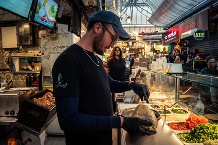 Jerusalem, Israel - February 17, 2026 The art of trade at Mahane Yehuda, showcasing merchants in...