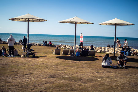 Tel Aviv, Israel, January 3, 2026 People engage in various leisure activities on the beach, from sports to relaxation, showcasing the defiant spirit of Life Goes On in the Mediterranean coastal city.のeditorial素材