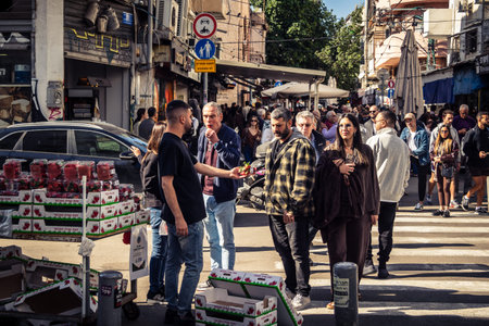 Tel Aviv, Israel, January 16, 2026 People in a vibrant daily scene at the heart of the famous Levinsky Market. Colorful stalls overflowing with Persian spices, dried fruits, and local specialties.のeditorial素材