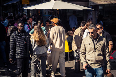Tel Aviv, Israel, January 16, 2026 People in a vibrant daily scene at the heart of the famous Levinsky Market. Colorful stalls overflowing with Persian spices, dried fruits, and local specialties.のeditorial素材