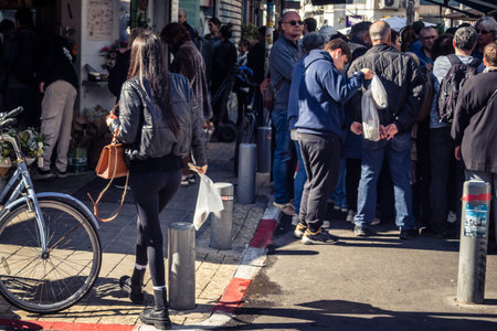 Tel Aviv, Israel, January 16, 2026 People in a vibrant daily scene at the heart of the famous Levinsky Market. Colorful stalls overflowing with Persian spices, dried fruits, and local specialties.のeditorial素材