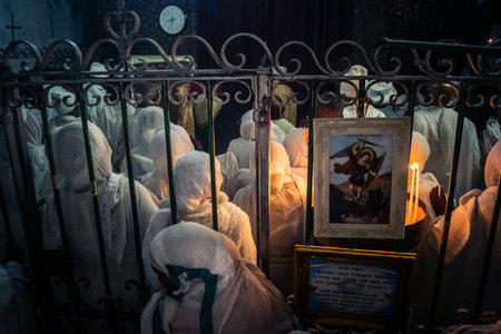 Jerusalem, Israel, 19 February 2026 Ethiopian Coptic Christian believers praying and prostrating during a religious ceremony inside the Ethiopian Church in the Old City. Deep devotion and faith scene.のeditorial素材