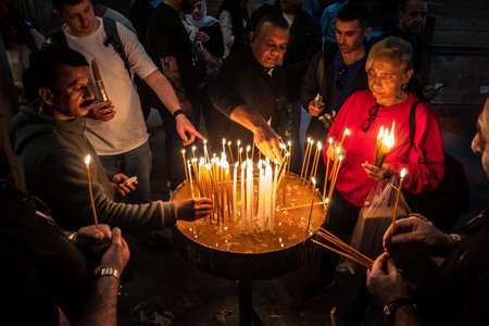 JERUSALEM, ISRAEL - FEBRUARY 21, 2026 Christian pilgrims lighting prayer candles in the mystic and...