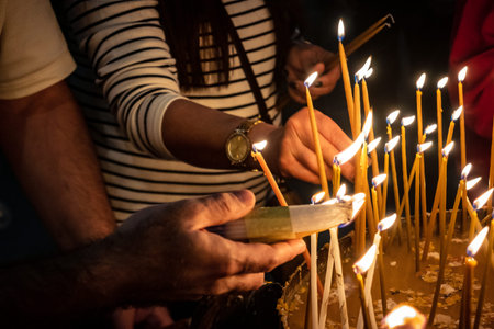 JERUSALEM, ISRAEL - FEBRUARY 21, 2026 Christian pilgrims lighting prayer candles in the mystic and...