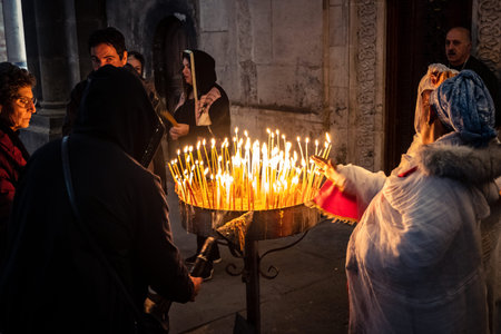 JERUSALEM, ISRAEL - FEBRUARY 21, 2026 Christian pilgrims lighting prayer candles in the mystic and...