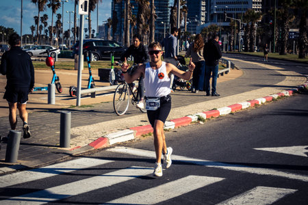 Tel Aviv, Israel, February 27, 2026 Large crowd of runners competing in the streets during the annual marathon, thousands of participants joining the major sporting event, urban race documentation and editorial photography.のeditorial素材
