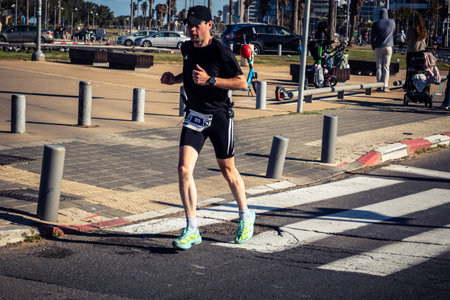 Tel Aviv, Israel, February 27, 2026 Large crowd of runners competing in the streets during the annual marathon, thousands of participants joining the major sporting event, urban race documentation and editorial photography.のeditorial素材