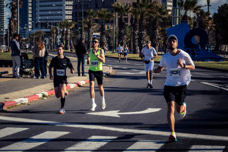 Tel Aviv, Israel, February 27, 2026 Large crowd of runners competing in the streets during the annual marathon, thousands of participants joining the major sporting event, urban race documentation and editorial photography.のeditorial素材
