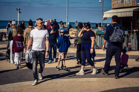 Tel Aviv, Israel, January 3, 2026 Passersby stroll along the Tel Aviv promenade facing the...