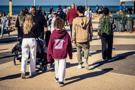 Tel Aviv, Israel, January 3, 2026 Passersby stroll along the Tel Aviv promenade facing the...