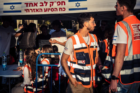 Tel Aviv, Israel, March 1, 2026 Volunteers organizing logistics and primary assistance for residents relocated due to urban destruction. The scene documents the scale of the civilian rescue and support operations in Tel Aviv.のeditorial素材