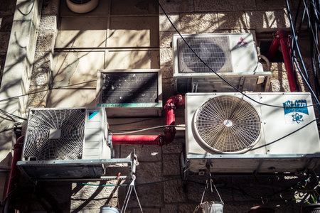 Jerusalem, Israel, February 20, 2026 Outdoor air conditioning units installed on the walls of...