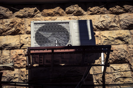 Jerusalem, Israel, February 20, 2026 Outdoor air conditioning units installed on the walls of residential buildings. These systems provide cooling and air conditioning in an urban environment.のeditorial素材