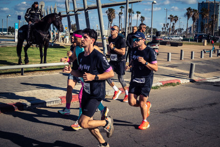 Tel Aviv, Israel, February 27, 2026 Large crowd of runners competing in the streets during the annual marathon, thousands of participants joining the major sporting event, urban race documentation and editorial photography.のeditorial素材