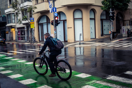 Tel Aviv, Israel, March 21, 2026 Street view of Tel Aviv under the rain with light reflections on...