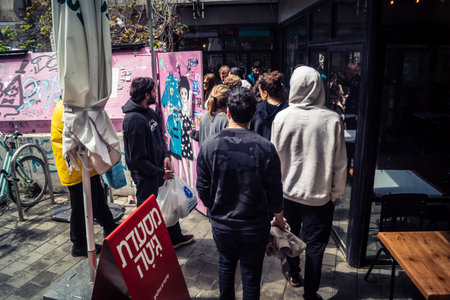 Tel Aviv, Israel, March 22, 2026 People rushing into a public bomb shelter or miklat and waiting inside during an air raid siren in the Florentin neighborhood while seeking protection during a missile attack.のeditorial素材