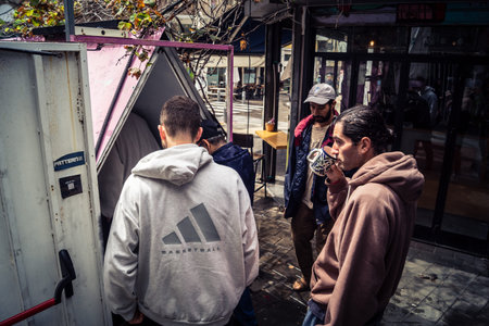 Tel Aviv, Israel, March 22, 2026 People rushing into a public bomb shelter or miklat and waiting inside during an air raid siren in the Florentin neighborhood while seeking protection during a missile attack.のeditorial素材