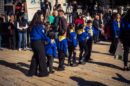 Bethlehem, West Bank, December 24, 2025 Young Palestinian scouts march in formation in the streets of Bethlehem during the annual Christmas parade. It is a central part of the cultural celebrations.のeditorial素材