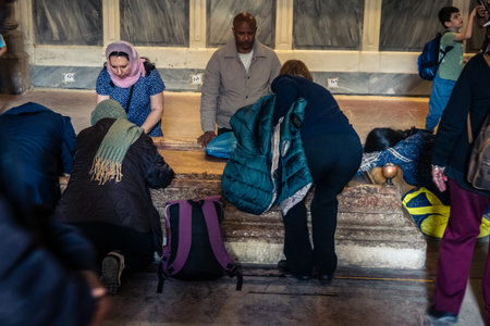 JERUSALEM, ISRAEL - FEBRUARY 16, 2026 Various global Christian denominations gathered in prayer in the Church of the Holy Sepulchre. Unity of faith, cultural diversity and unique religious fervor.のeditorial素材