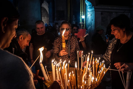 JERUSALEM, ISRAEL - FEBRUARY 21, 2026 Christian pilgrims lighting prayer candles in the mystic and...