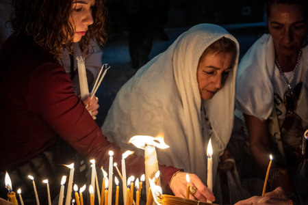 JERUSALEM, ISRAEL - FEBRUARY 21, 2026 Christian pilgrims lighting prayer candles in the mystic and...