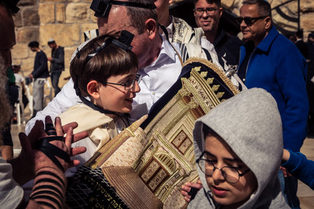 Jerusalem, Israel - February 18, 2026. Bar Mitzvah celebration at the Kotel. Religious rite of passage marking the transition to maturity at the holiest site in Judaism.のeditorial素材