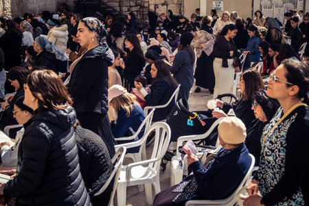 Jerusalem, Israel - February 18, 2026. Deep devotion in the Western Wall women's section. Solitary...
