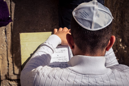 Jerusalem, Israel - February 18, 2026. Close-up of Jewish men absorbed in studying the Torah or Psalms at the Kotel. Transmission of religious knowledge.のeditorial素材