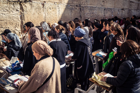 Jerusalem, Israel - February 18, 2026. Deep devotion in the Western Wall women's section. Solitary...