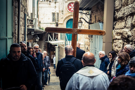 Jerusalem, Israel, 19 February 2026  Italian Christian pilgrims led by a priest conduct an official procession along the Via Dolorosa in the Old City. Devotees carry a cross through narrow streets.のeditorial素材
