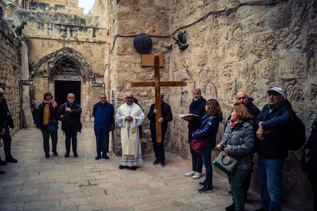 â€‹Jerusalem, Israel - February 21, 2026: Christian pilgrims carry large wooden crosses and...