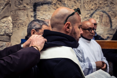 â€‹Jerusalem, Israel - February 21, 2026: Christian pilgrims carry large wooden crosses and...
