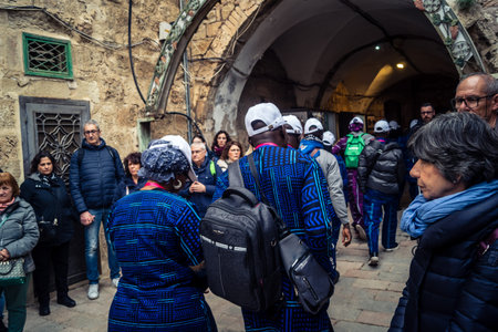 â€‹Jerusalem, Israel - February 21, 2026: Christian pilgrims carry large wooden crosses and...