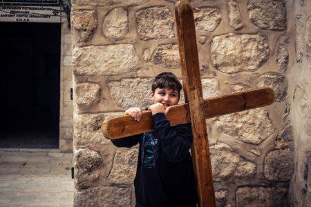 â€‹Jerusalem, Israel - February 21, 2026: Christian pilgrims carry large wooden crosses and...