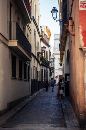 Seville, Spain, September 21, 2025 Tourists visit the historic district of downtown Seville and walk through the narrow, picturesque streets.のeditorial素材